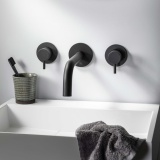 Product Lifestyle image of the JTP Vos Brushed Black Slim Bath/Basin Spout flanked by Vos Brushed Black Wall Valves